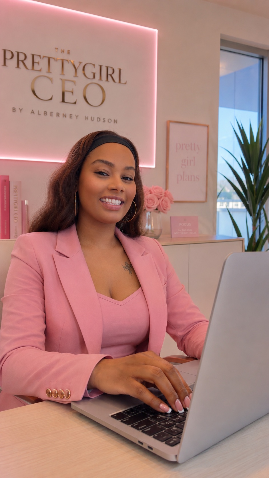 Alberney Hudson, founder of PrettyGirlCEO, working in the PrettyGirlCEO office